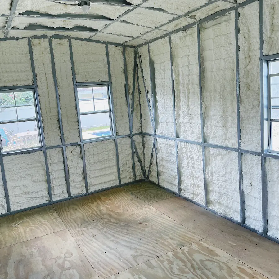 Closed-cell spray foam insulation applied to wall cavities in a residential project in Bear